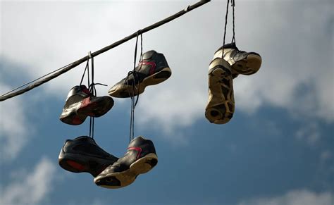 why are there shoes on power lines|hanging sneakers.